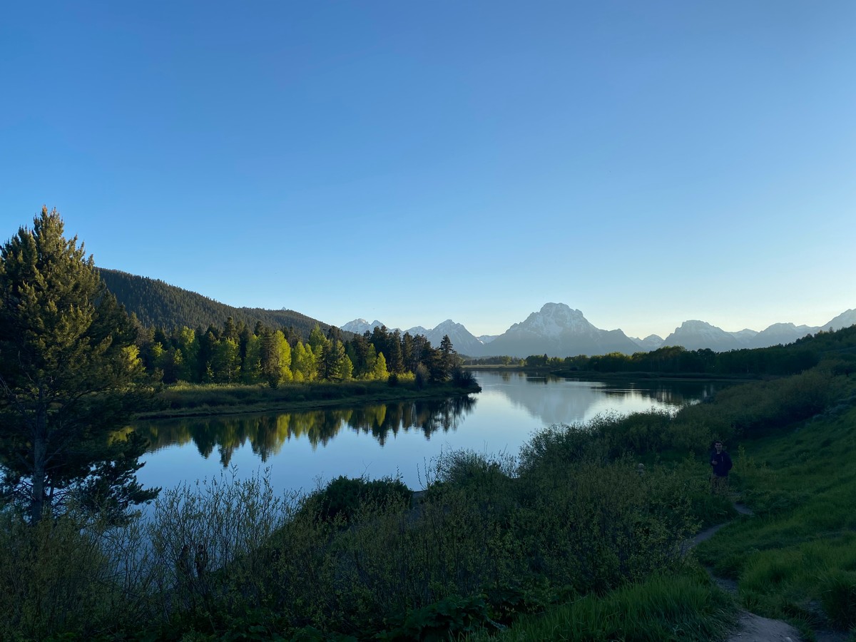 a lake surrounded by trees and mountains