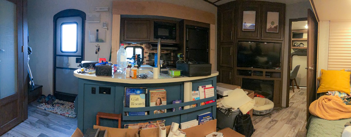 a kitchen counter with a microwave oven and boxes on it