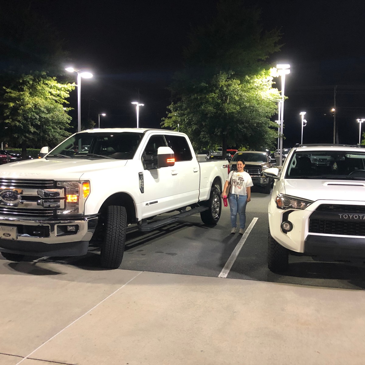 a person standing next to a white truck