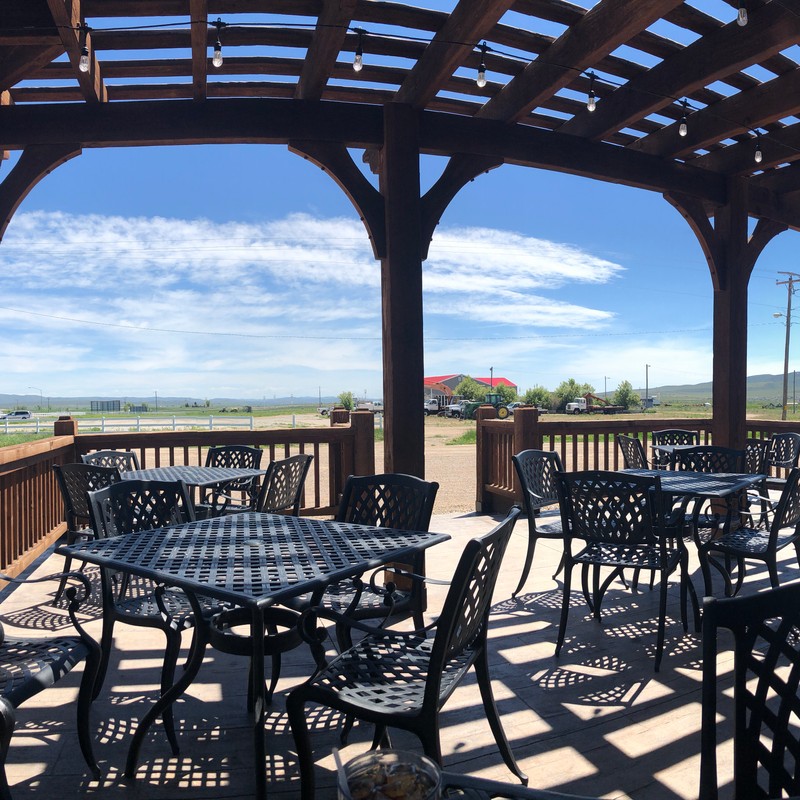 a patio with tables and chairs