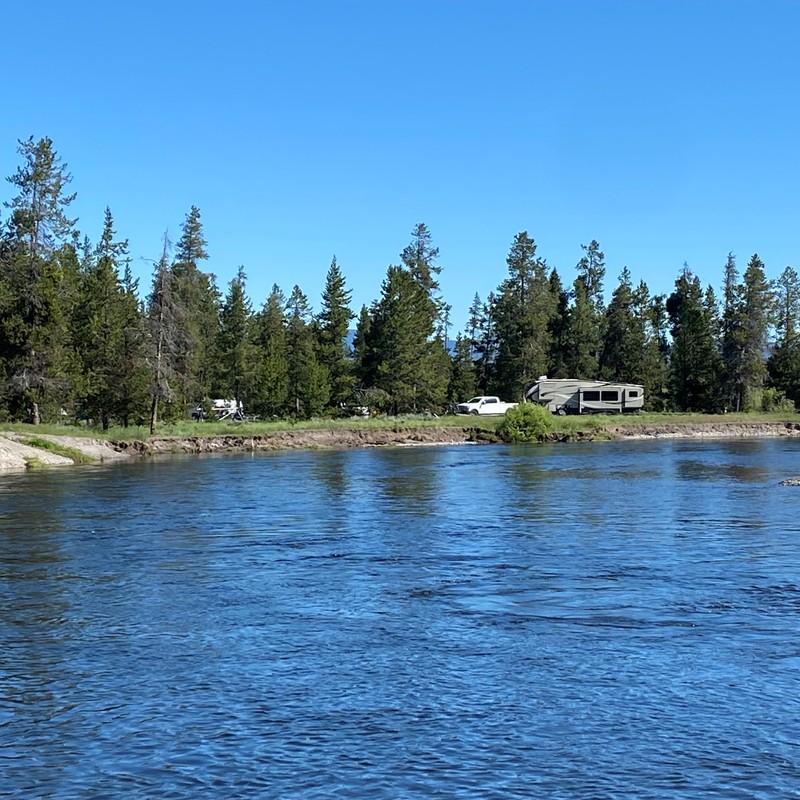 a lake with trees and a house