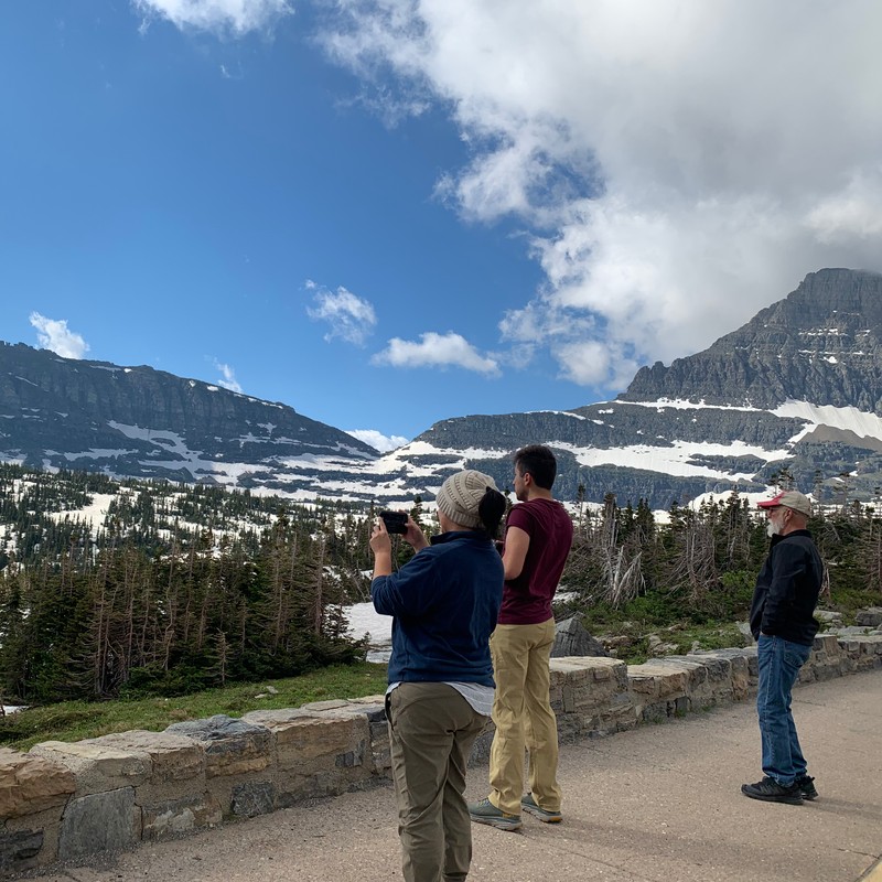 a group of people looking at a mountain range