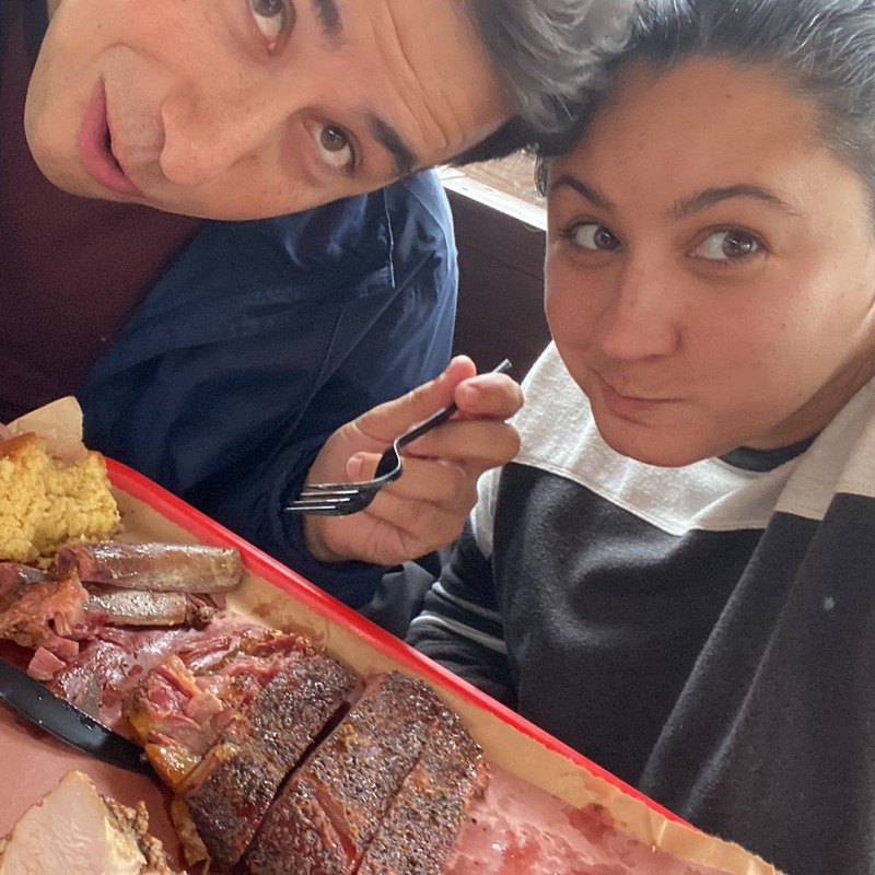 a man and a woman looking at a plate of food