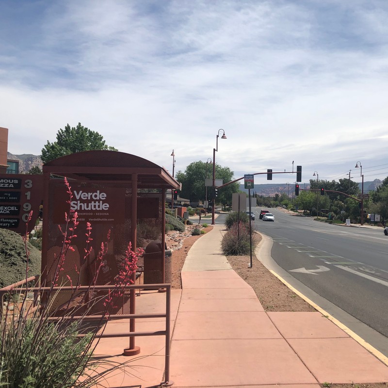 a sidewalk with a red booth