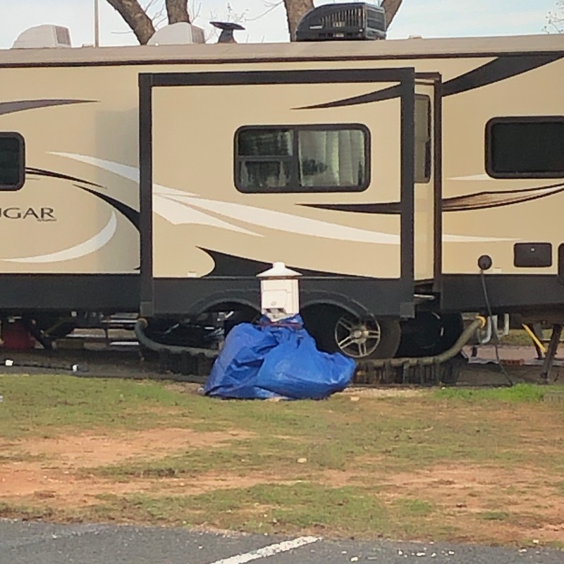 a white van with a blue bag on the ground