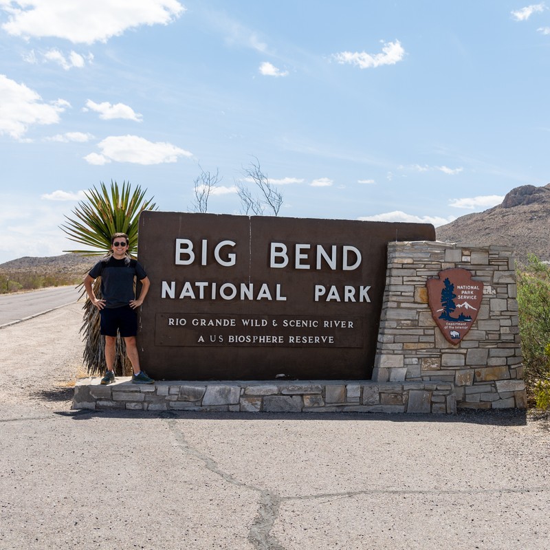 a person standing next to a sign