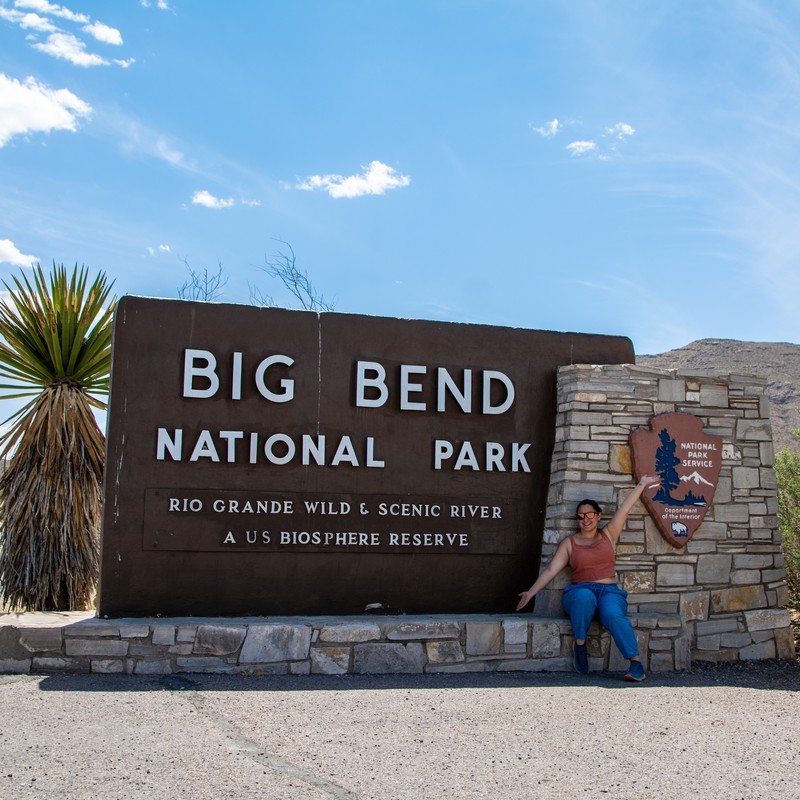 a person posing in front of a sign