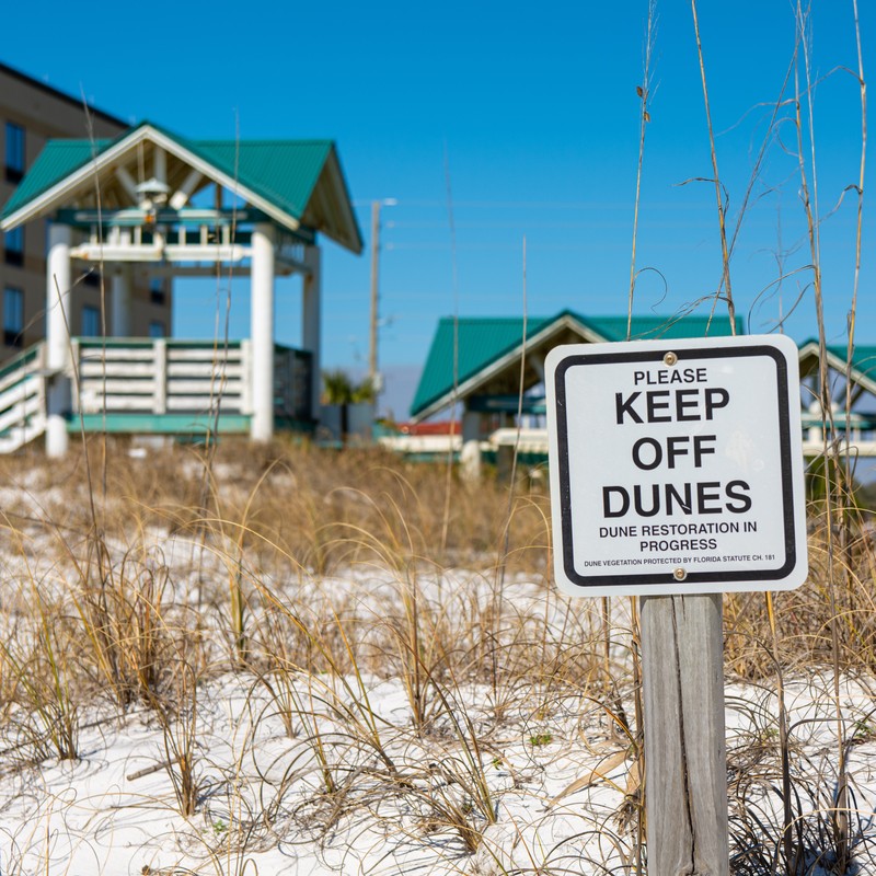a sign in front of a beach