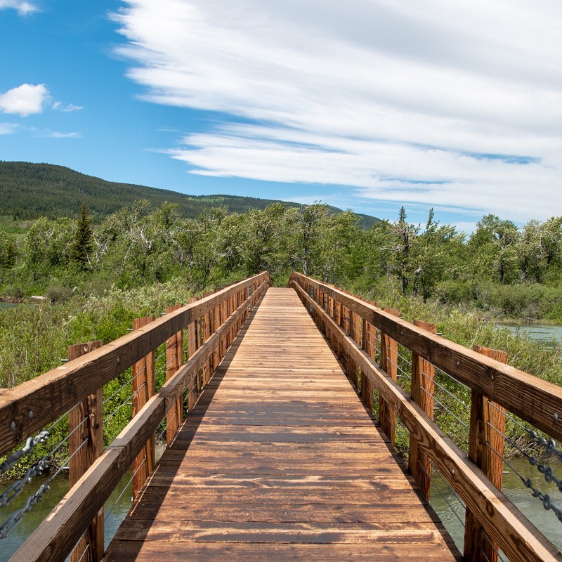 a wooden bridge over a river