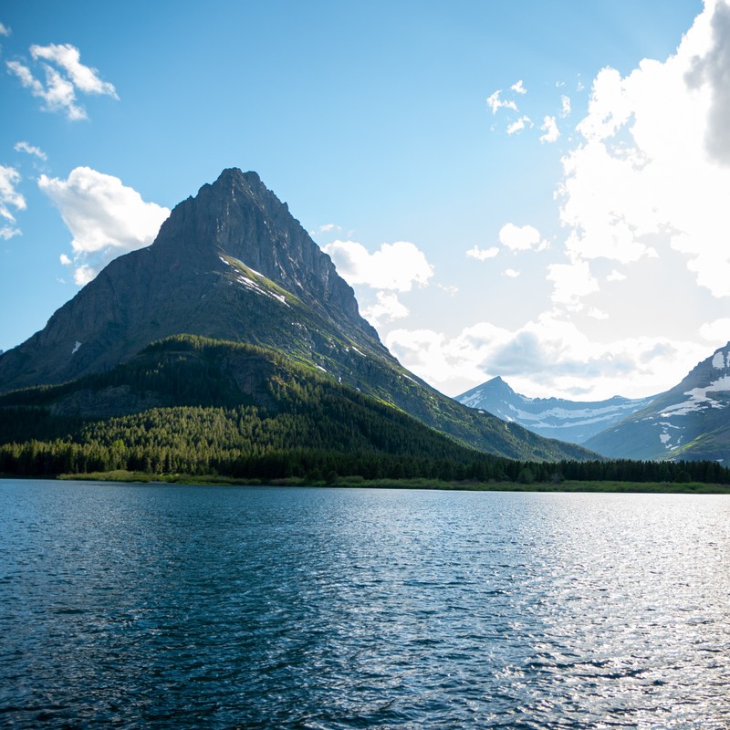 a body of water with a mountain in the background