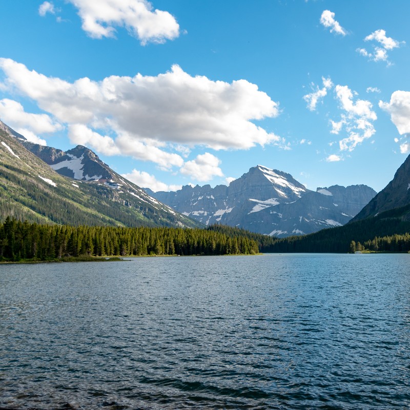 a body of water with mountains in the background