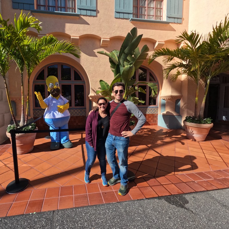 a man and woman posing with a statue of a man