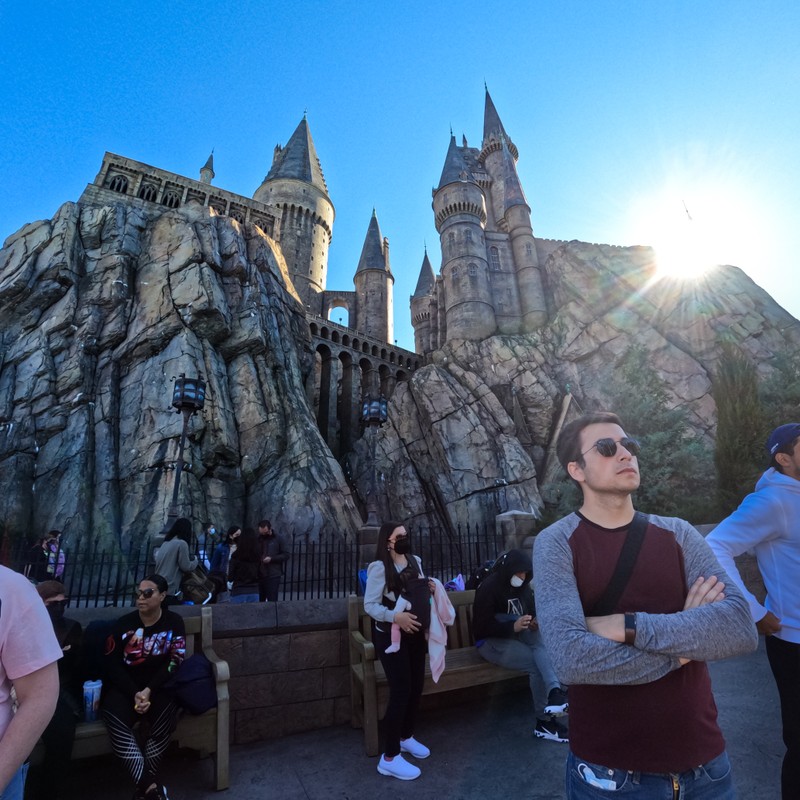 a person posing in front of a castle