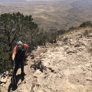 a person hiking on a rocky hill