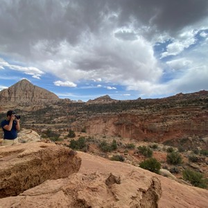 a person taking a picture of a canyon