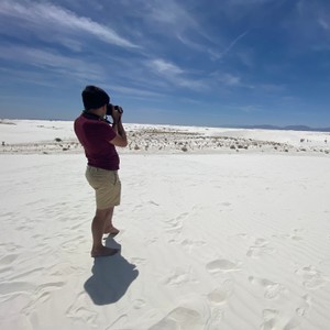 a man taking a picture of himself in the sand