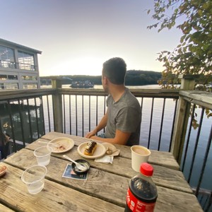 a person sitting at a table with food on it