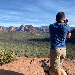 a man standing on a rock overlooking a valley