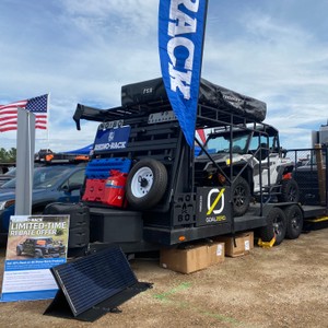 a black truck with a flag on top