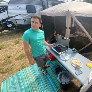 a person standing next to a laptop