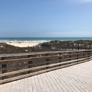 a wooden deck overlooking a beach