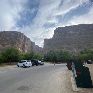 a road with cars and mountains in the background