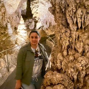 a person standing next to a rock