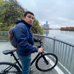 a man standing next to a bicycle