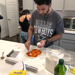 a person cutting a pizza