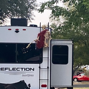 a person in a garment standing on the back of a truck