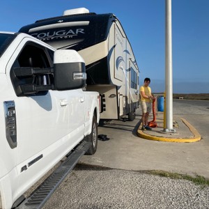 a person standing next to a white truck