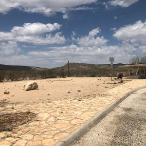 a road with rocks and a fence