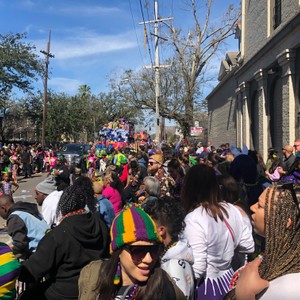 a crowd of people walking down a street