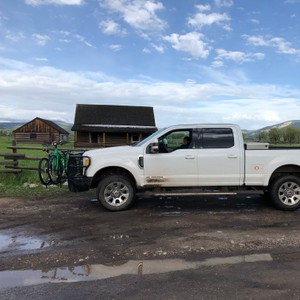 a white truck with a bike on the back