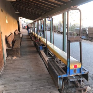 a train with a person walking on the platform