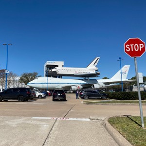 a stop sign in front of an airplane