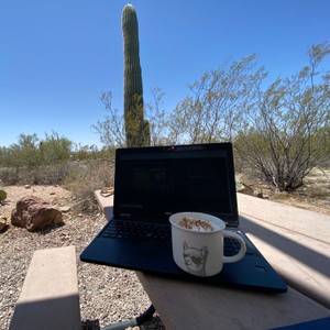 a laptop and a cup of coffee on a table