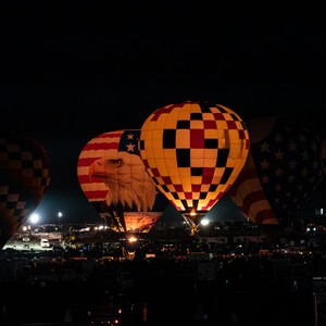 a group of hot air balloons at night