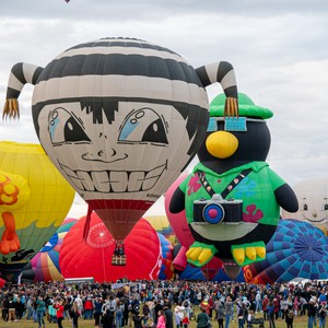 a group of people inflatable hot air balloons