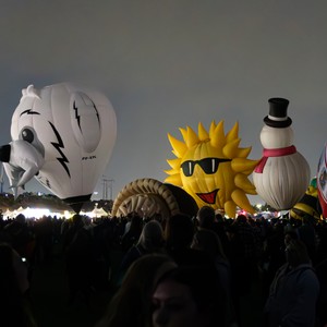 a crowd of people with a large white and yellow object in the middle