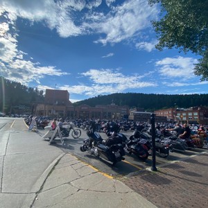 a row of motorcycles parked on a street