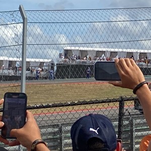 a baseball player taking a picture of a baseball game