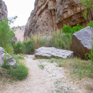 a dirt path between large rocks