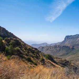 a valley with mountains in the background