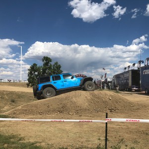 a blue truck on a dirt road