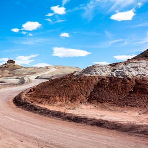 a dirt road with a blue sky