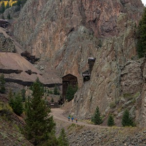 a group of people walking through a cave in a mountain