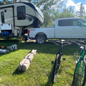 a bicycle and a camper in a grassy area