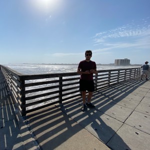 a man standing on a boardwalk