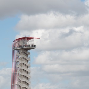 a tall building with a red and white top